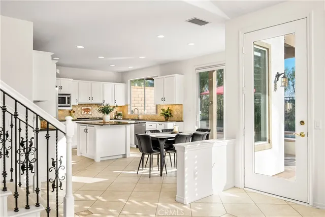 a kitchen with a sink refrigerator and cabinets