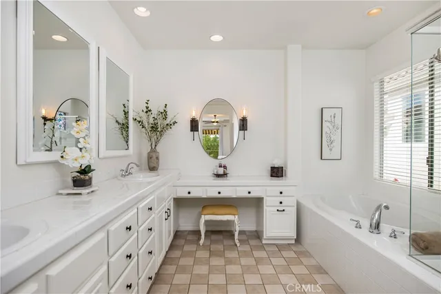 a bathroom with a bathtub sink and mirror