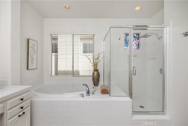 a bathroom with a tub sink and mirror