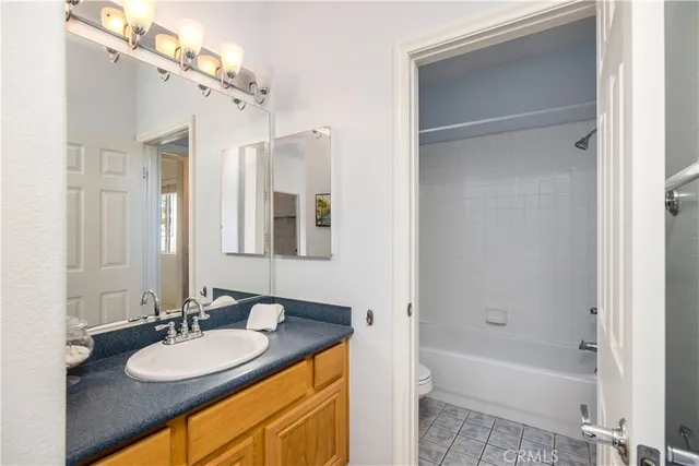a bathroom with a granite countertop sink tub and a mirror