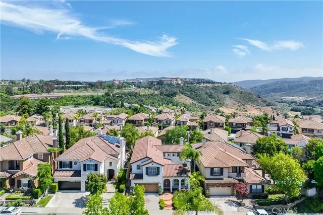 an aerial view of residential houses with city view