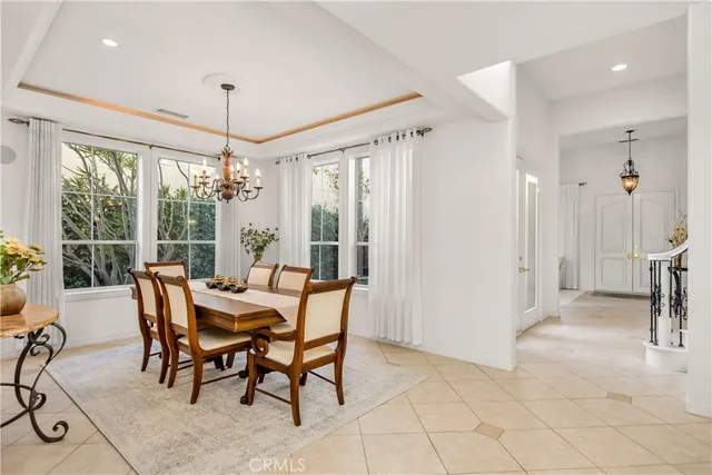 a dining room with furniture water view and a chandelier