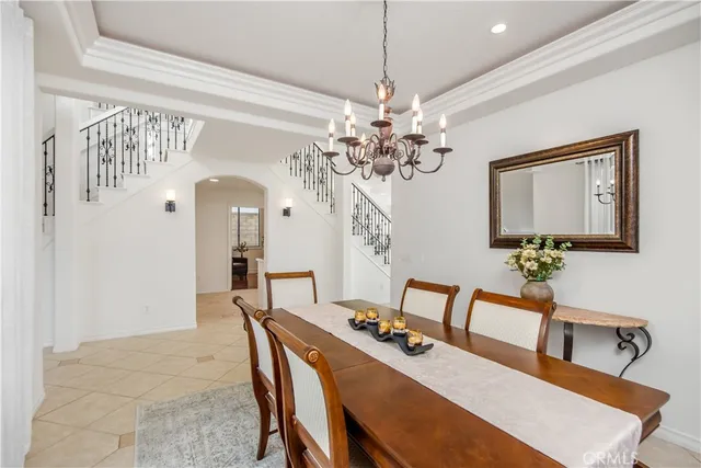 a view of a dining room with furniture and a chandelier