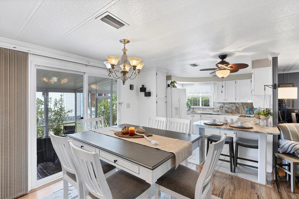 10303 Burnt Store Road, Unit 5 Punta Gorda, FL 33950 - Photo 15 of 49 a view of a dining room with furniture window and wooden floor