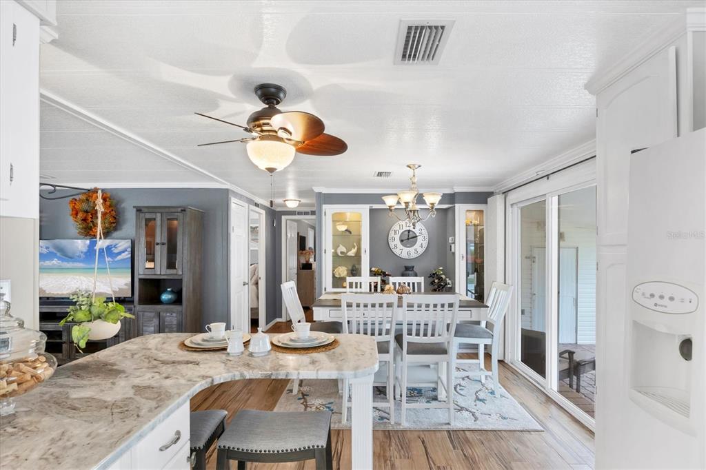 10303 Burnt Store Road, Unit 5 Punta Gorda, FL 33950 - Photo 16 of 49 a view of a dining room with furniture and a chandelier
