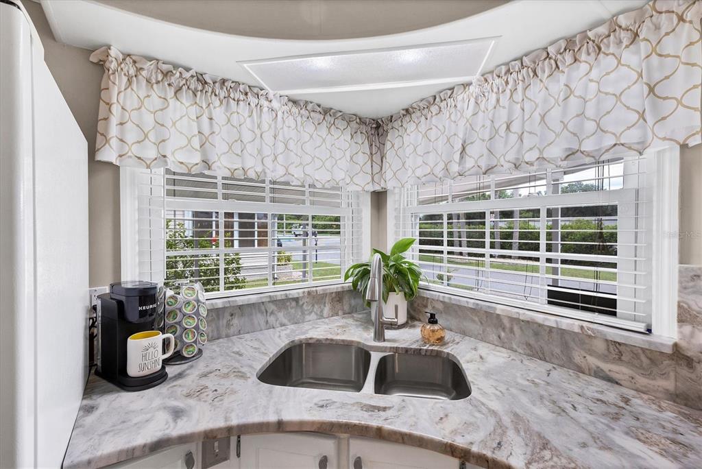 10303 Burnt Store Road, Unit 5 Punta Gorda, FL 33950 - Photo 20 of 49 a view of a sink and dishwasher with wooden floor