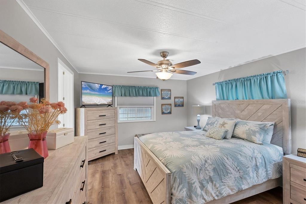 10303 Burnt Store Road, Unit 5 Punta Gorda, FL 33950 - Photo 21 of 49 a bedroom with a bed and a chandelier