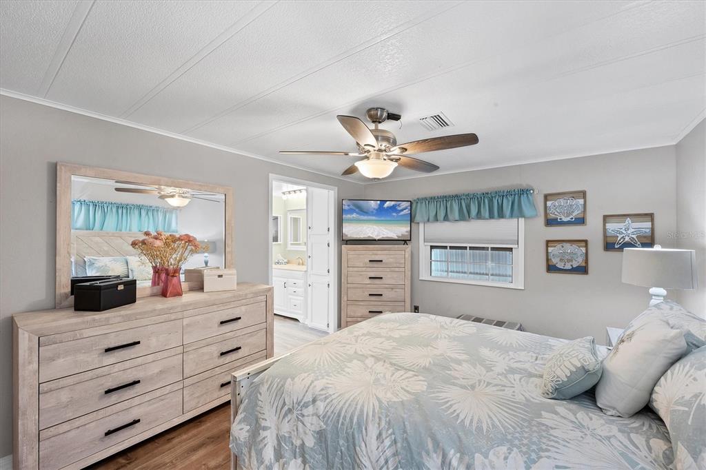 10303 Burnt Store Road, Unit 5 Punta Gorda, FL 33950 - Photo 22 of 49 a bedroom with a large bed and a dresser