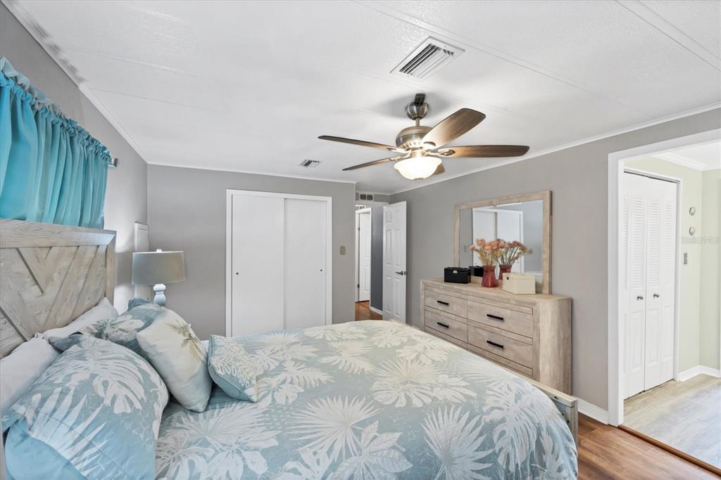 10303 Burnt Store Road, Unit 5 Punta Gorda, FL 33950 - Photo 23 of 49 a bedroom with a bed and a chandelier