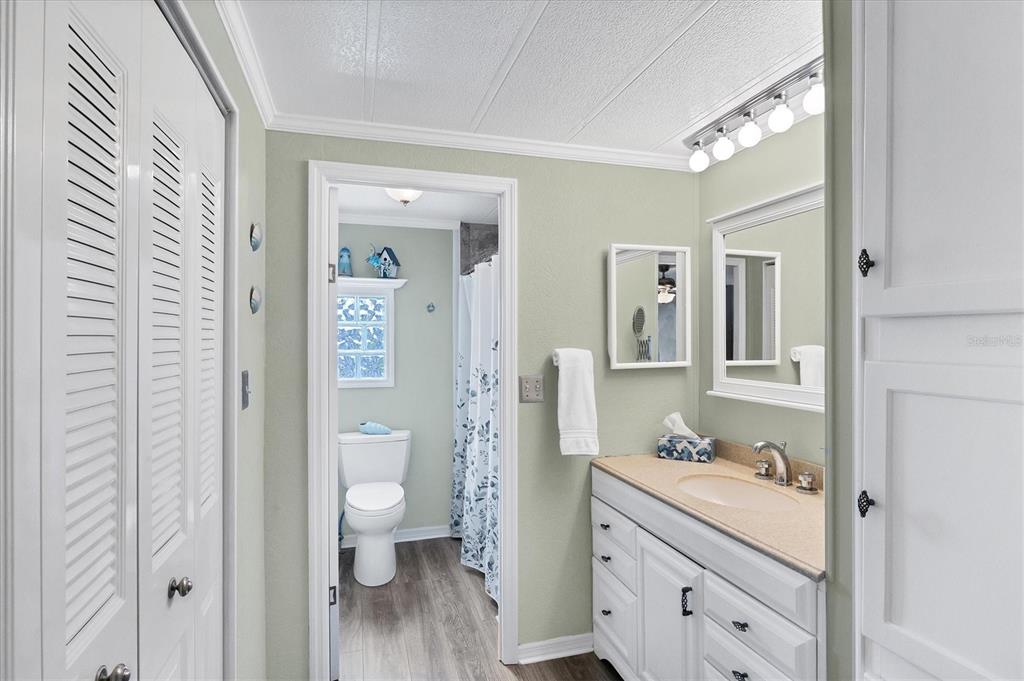 10303 Burnt Store Road, Unit 5 Punta Gorda, FL 33950 - Photo 24 of 49 a bathroom with a sink a toilet and a view of bathroom