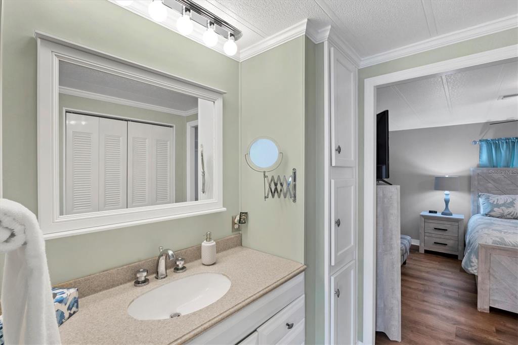 10303 Burnt Store Road, Unit 5 Punta Gorda, FL 33950 - Photo 25 of 49 a en suite bathroom with a sink and a mirror