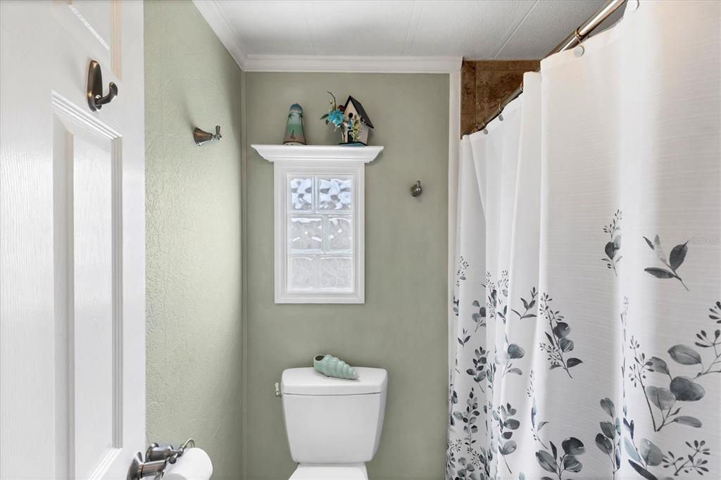 10303 Burnt Store Road, Unit 5 Punta Gorda, FL 33950 - Photo 26 of 49 a bathroom with a toilet sink and shower curtain