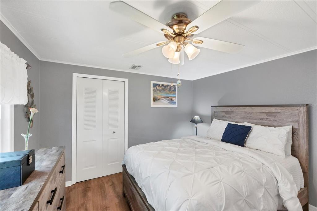 10303 Burnt Store Road, Unit 5 Punta Gorda, FL 33950 - Photo 27 of 49 a bedroom with a bed and wooden floor