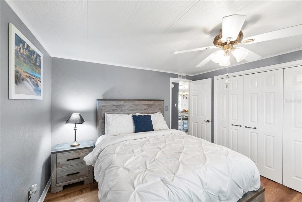 10303 Burnt Store Road, Unit 5 Punta Gorda, FL 33950 - Photo 28 of 49 a large bed sitting in a bedroom and a chandelier