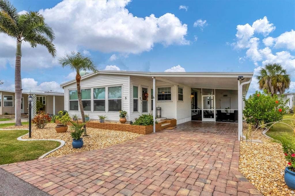 10303 Burnt Store Road, Unit 5 Punta Gorda, FL 33950 - Photo 3 of 49 a view of a house with backyard porch and sitting area