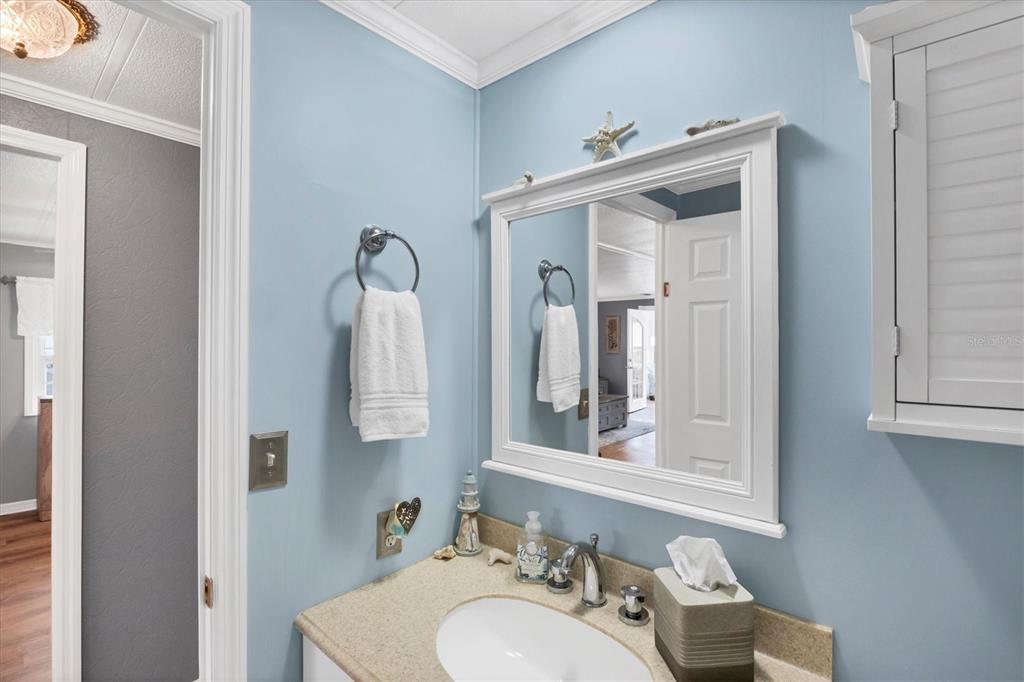 10303 Burnt Store Road, Unit 5 Punta Gorda, FL 33950 - Photo 31 of 49 a bathroom with a sink vanity and mirror