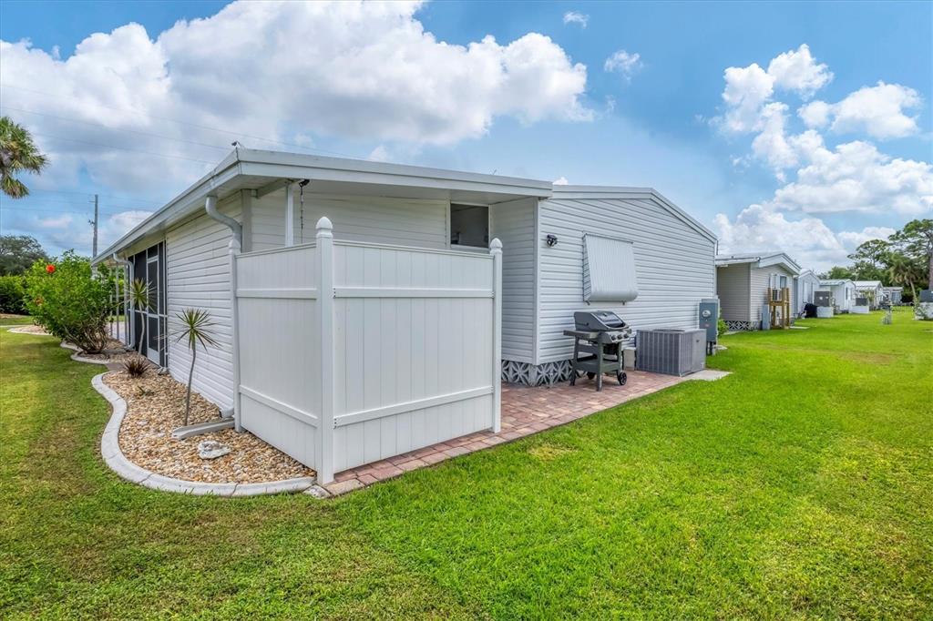 10303 Burnt Store Road, Unit 5 Punta Gorda, FL 33950 - Photo 35 of 49 a view of a house with a yard and sitting area