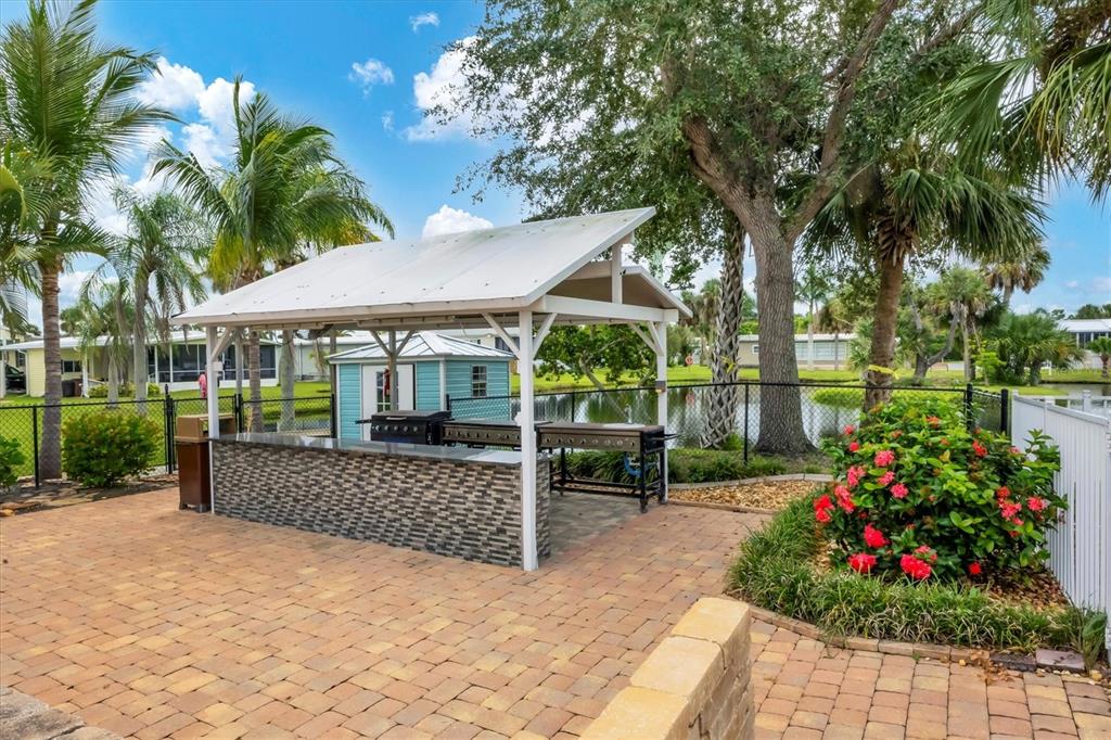 10303 Burnt Store Road, Unit 5 Punta Gorda, FL 33950 - Photo 40 of 49 a view of a chair and table in the garden