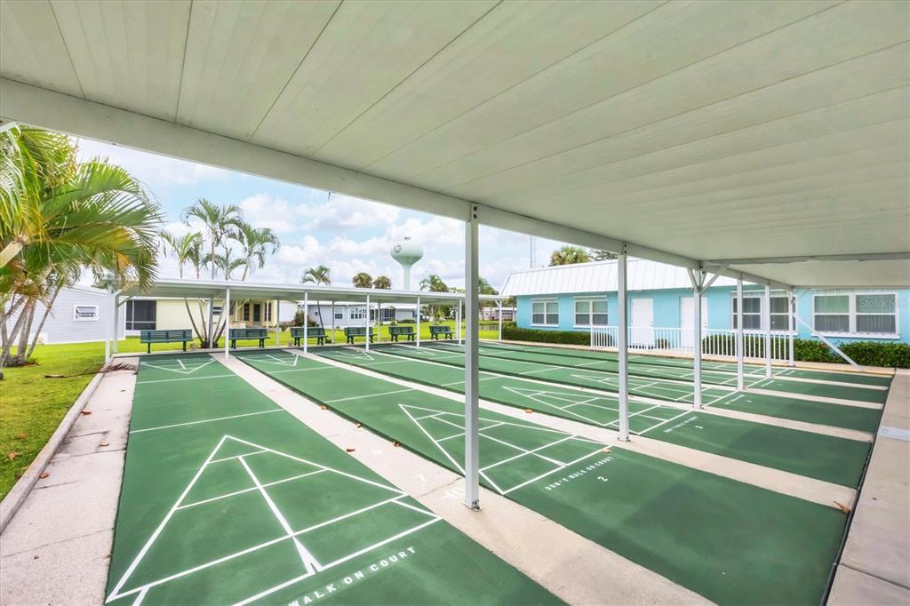 10303 Burnt Store Road, Unit 5 Punta Gorda, FL 33950 - Photo 41 of 49 a view of a tennis ground with large trees