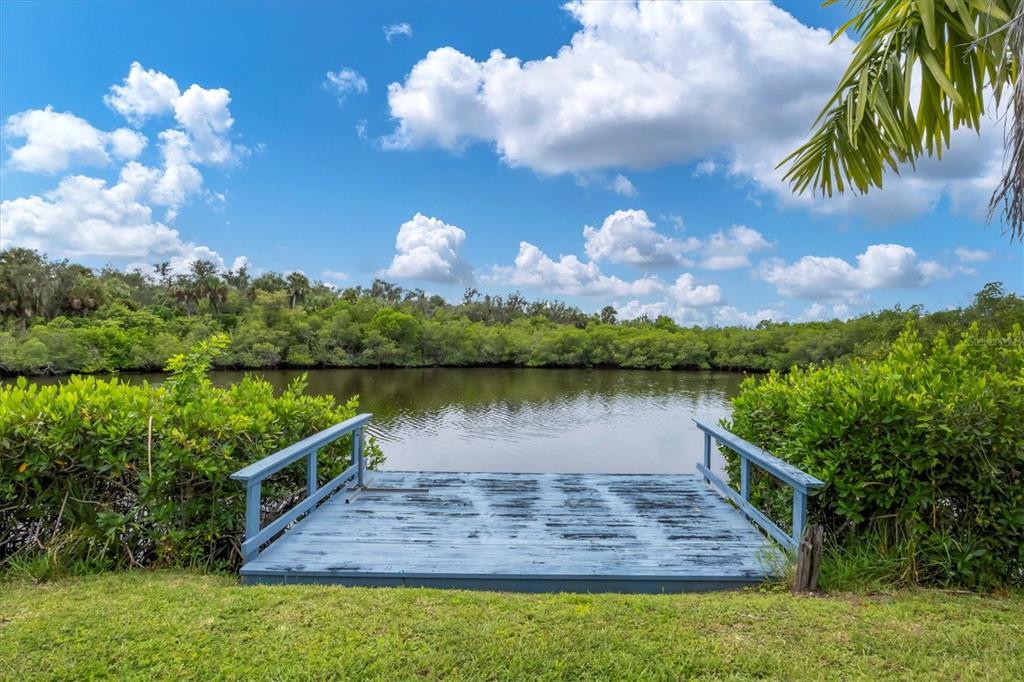 10303 Burnt Store Road, Unit 5 Punta Gorda, FL 33950 - Photo 43 of 49 a view of a lake with a yard