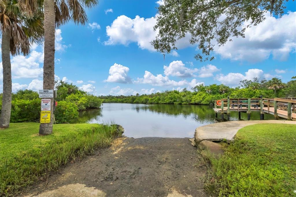 10303 Burnt Store Road, Unit 5 Punta Gorda, FL 33950 - Photo 44 of 49 a view of a lake with houses in the back