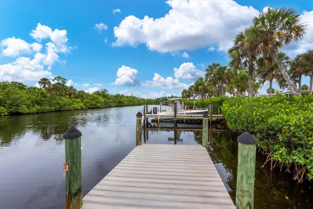 10303 Burnt Store Road, Unit 5 Punta Gorda, FL 33950 - Photo 47 of 49 a lake view with a sitting space and garden view