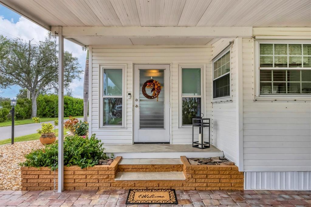 10303 Burnt Store Road, Unit 5 Punta Gorda, FL 33950 - Photo 5 of 49 a front view of a house with garden