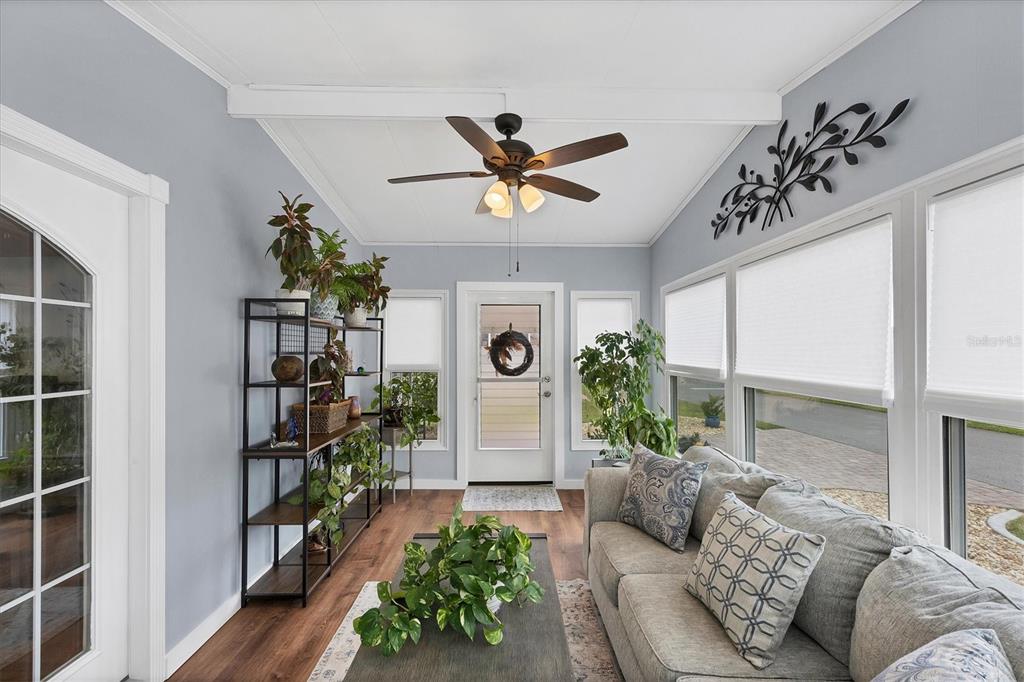 10303 Burnt Store Road, Unit 5 Punta Gorda, FL 33950 - Photo 6 of 49 a living room with furniture a chandelier and a window