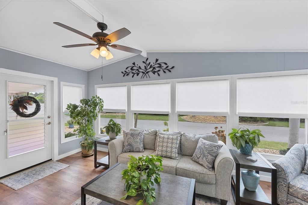 10303 Burnt Store Road, Unit 5 Punta Gorda, FL 33950 - Photo 8 of 49 a living room with furniture and a large window with potted plants