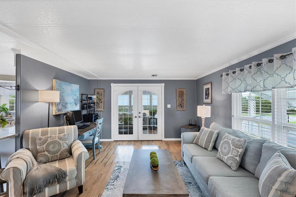 10303 Burnt Store Road, Unit 5 Punta Gorda, FL 33950 - Photo 9 of 49 a living room with furniture and a large window