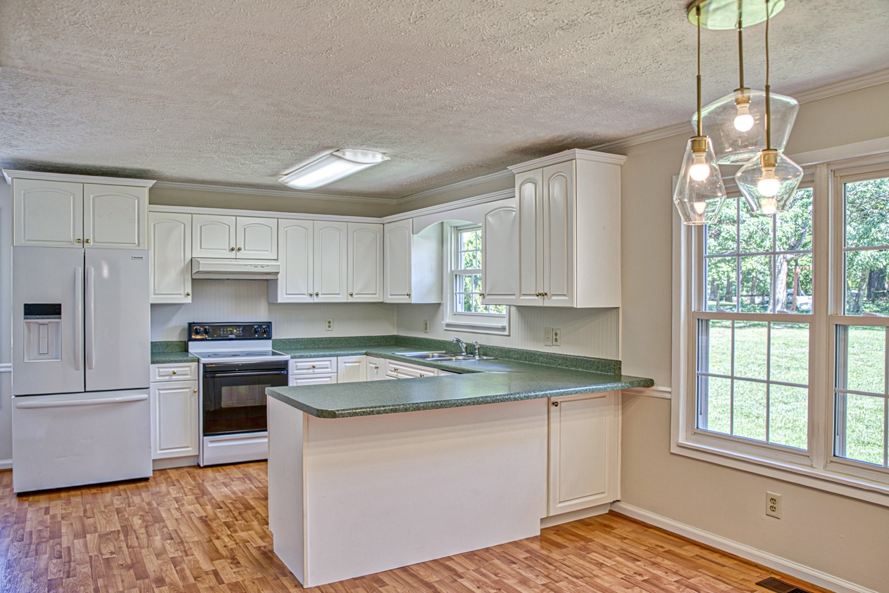 2085 Herbert Garrett Road Cookeville, TN 38506 - Photo 16 of 39 a kitchen with stainless steel appliances granite countertop a sink stove and refrigerator