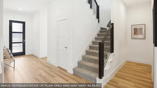 a view of staircase with white walls and a window