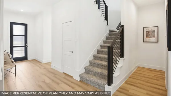 a view of staircase with white walls and a window