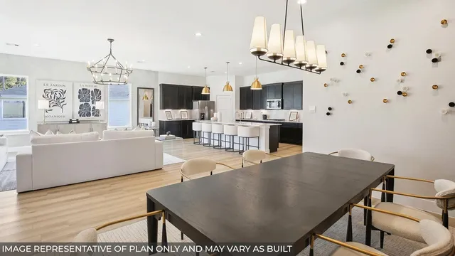 a living room with furniture a fireplace and a chandelier