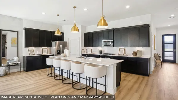 a living room with stainless steel appliances kitchen island granite countertop a table chairs and a sink