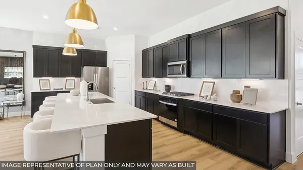 a kitchen with kitchen island granite countertop a sink cabinets and stainless steel appliances