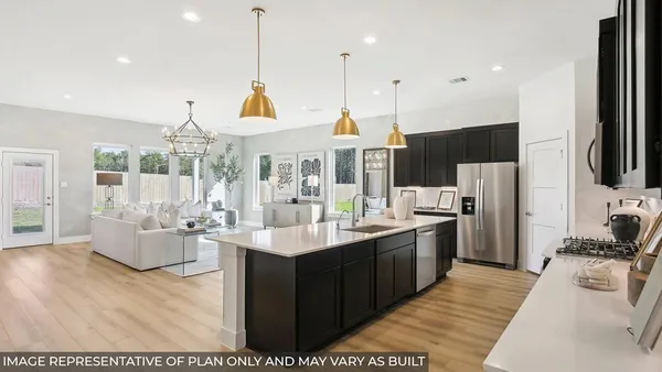 a large kitchen with stainless steel appliances kitchen island granite countertop a sink and cabinets
