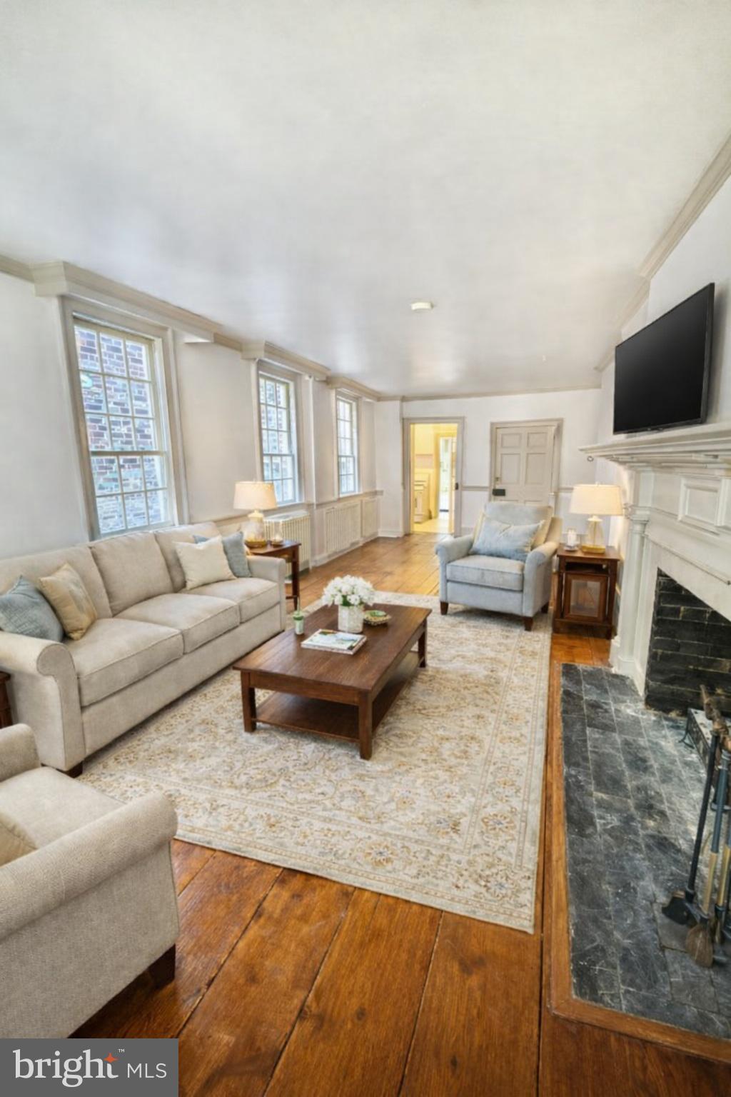 119 Prince Street, Unit 1 Alexandria, VA 22314 - Photo 1 of 29 a living room with furniture and a flat screen tv