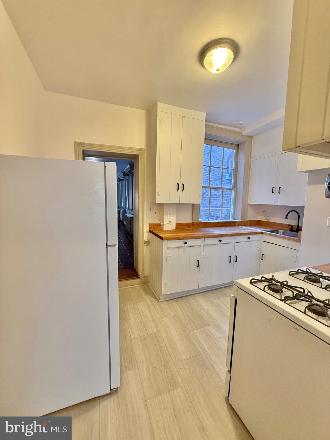 119 Prince Street, Unit 1 Alexandria, VA 22314 - Photo 11 of 29 a kitchen with stainless steel appliances a refrigerator sink and cabinets