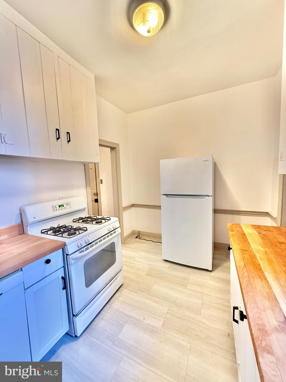 119 Prince Street, Unit 1 Alexandria, VA 22314 - Photo 8 of 29 a kitchen with stainless steel appliances granite countertop a stove a sink and a refrigerator