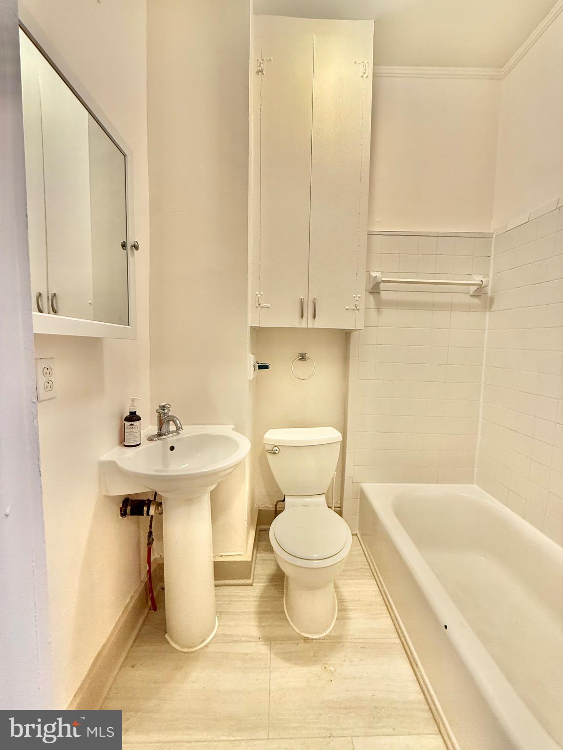 119 Prince Street, Unit 1 Alexandria, VA 22314 - Photo 9 of 29 a bathroom with a sink toilet and shower