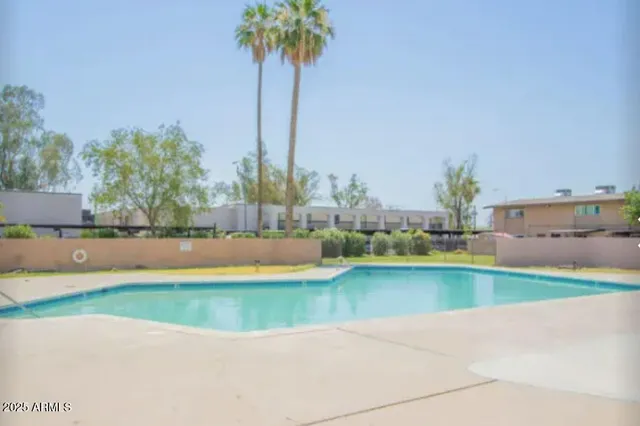 a view of a swimming pool and a yard