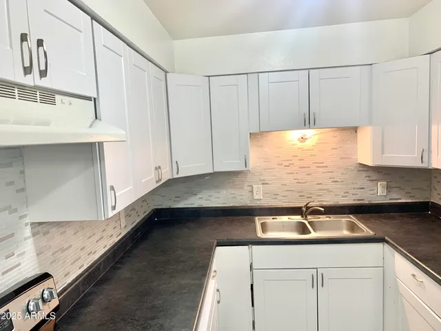 a kitchen with a sink and cabinets