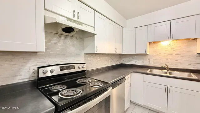 a kitchen with a stove microwave and cabinets