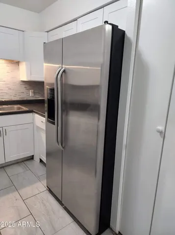 a kitchen with metallic refrigerator freezer and a dishwasher
