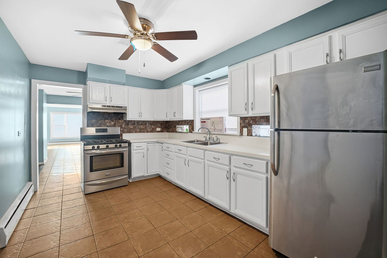 9209 South State Street Chicago, IL 60619 - Photo 9 of 20 a kitchen with cabinets stainless steel appliances and a window