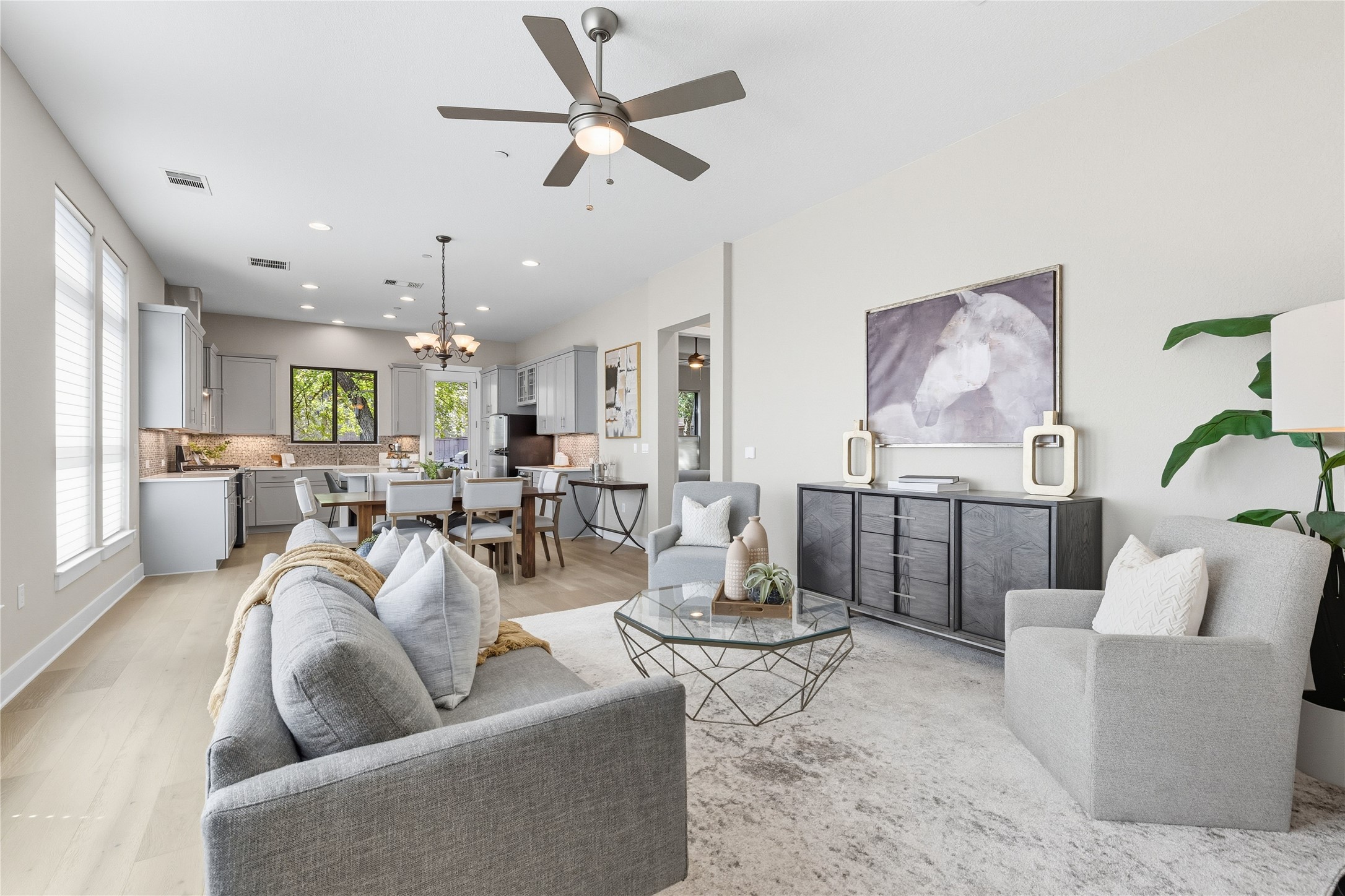 a living room with furniture and a view of kitchen