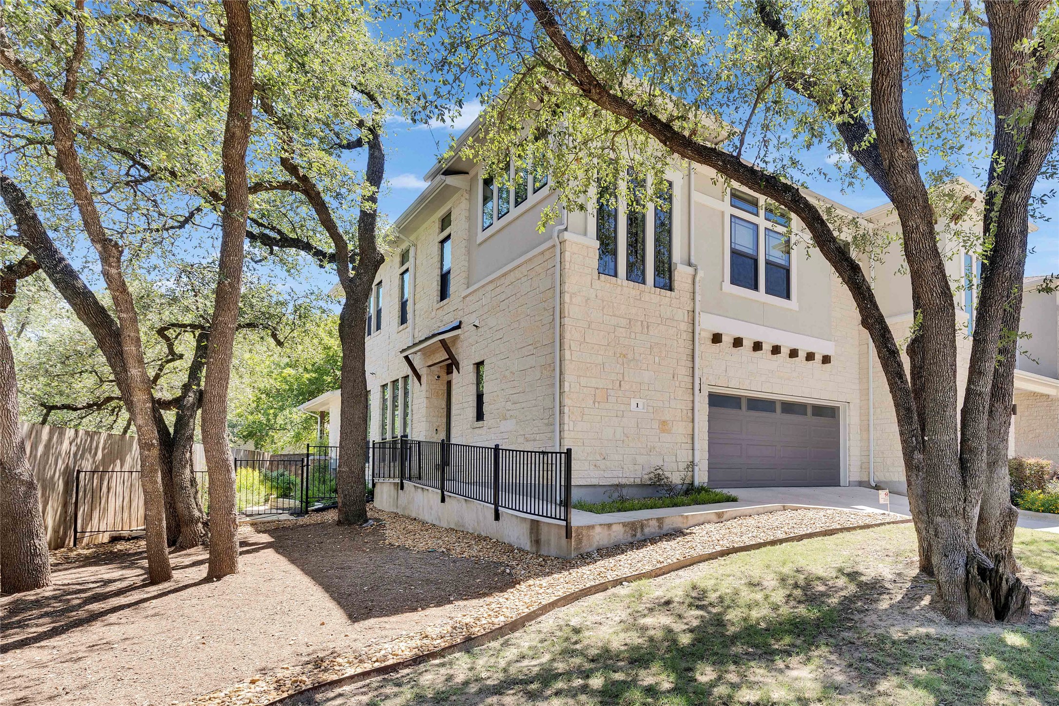 4323 Spicewood Springs Road, Unit 1 Austin, TX 78759 - Photo 2 of 35 a view of a white house with a large tree