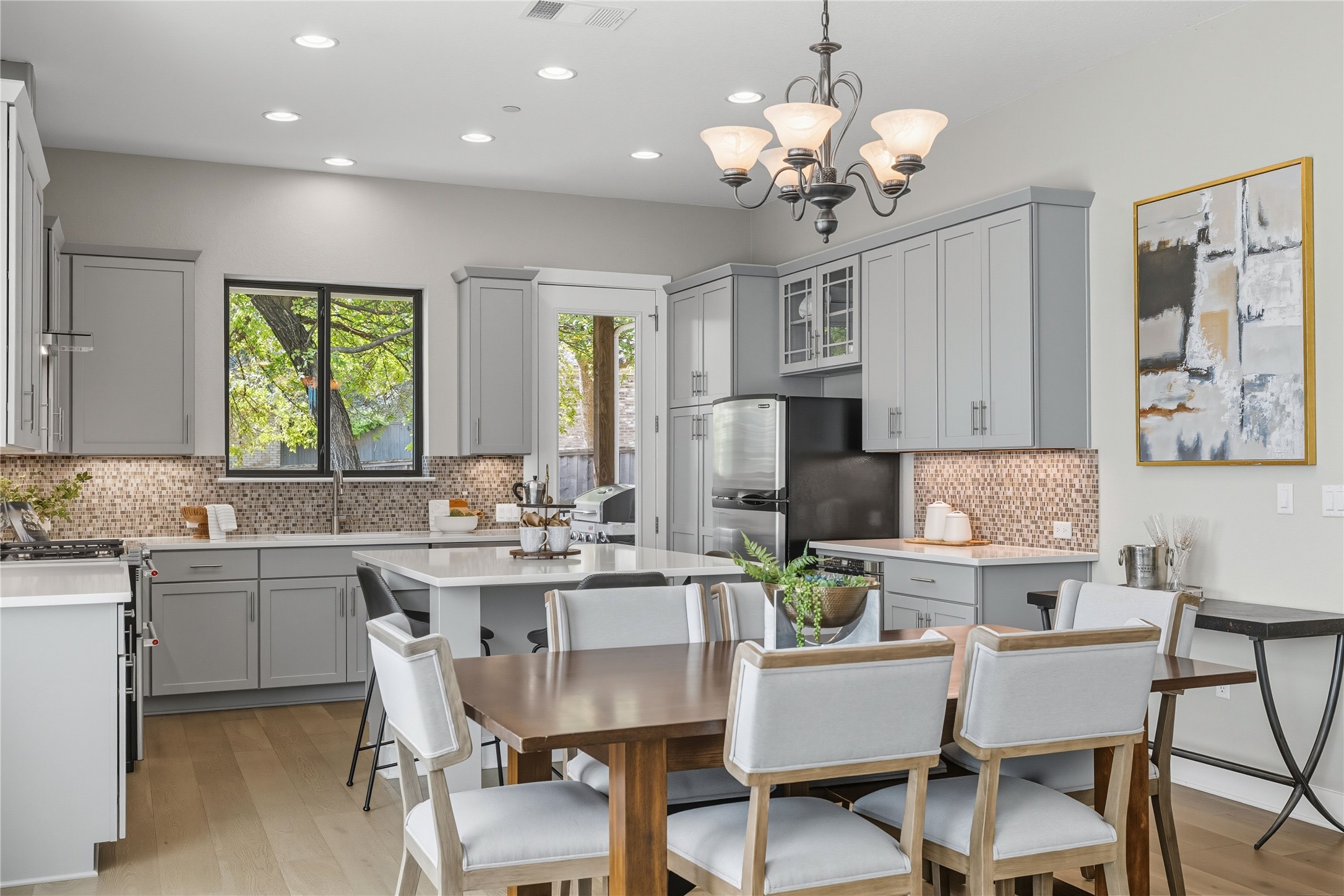 4323 Spicewood Springs Road, Unit 1 Austin, TX 78759 - Photo 5 of 35 a dining room filled chandelier and kitchen view