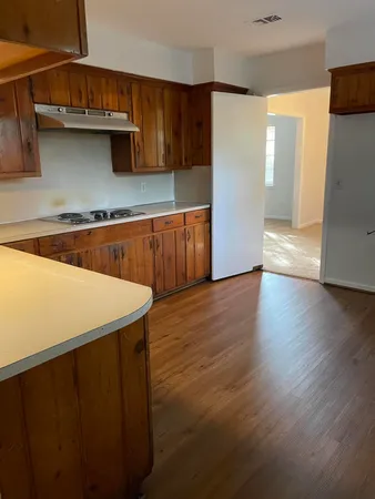a kitchen with stainless steel appliances a refrigerator and a stove top oven